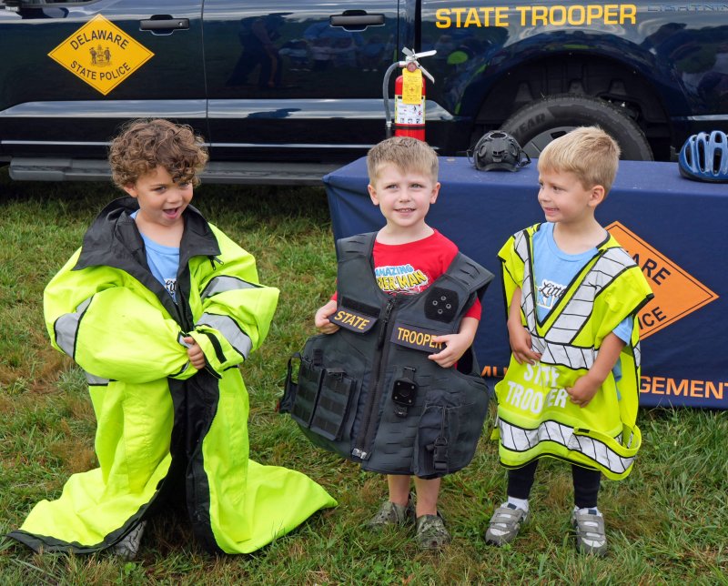 These state trooper vests and jacket are a little big on Little Vikings students (l-r) Asher Natoli, John “Cohen” Jones and Carter Denyus.